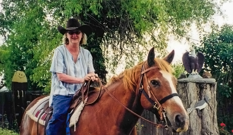 A past photo of Chris in her cowboy hat outside for an adventure horse riding captures the essence of freedom.