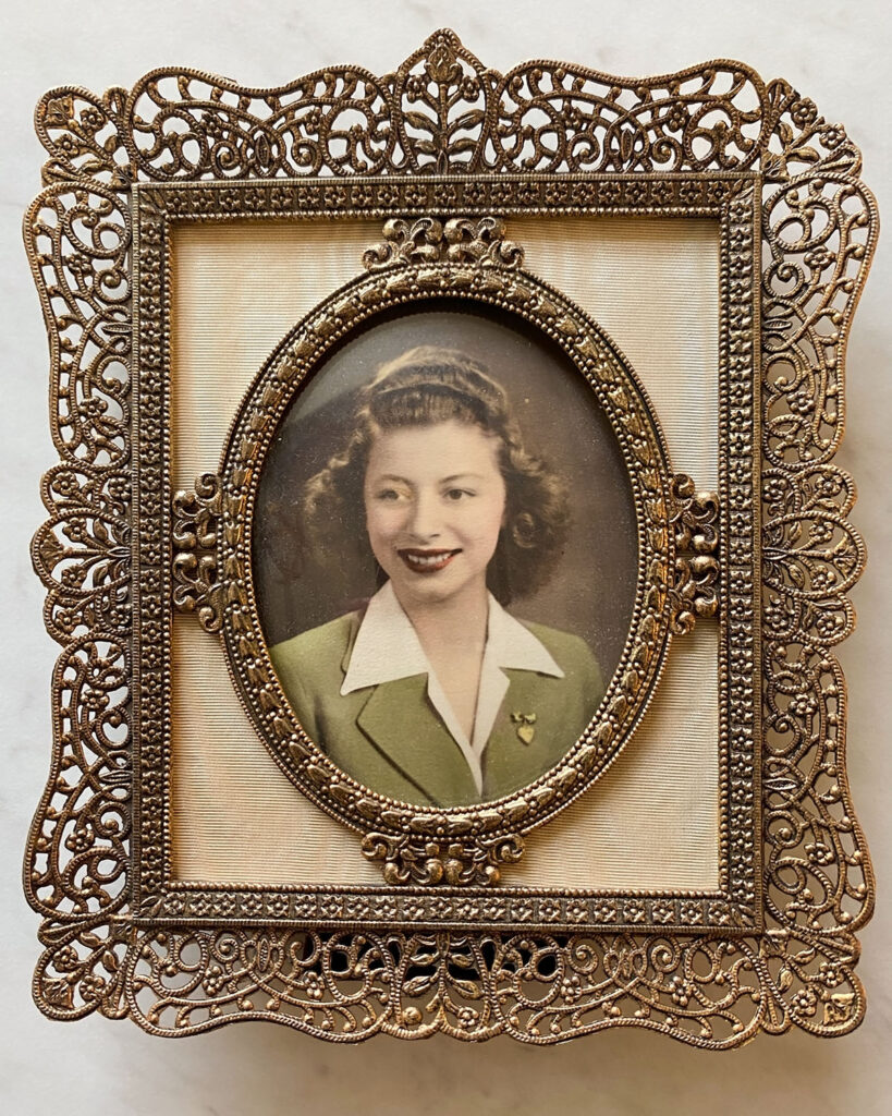 A captivating vintage photo of Joann, a woman encased in a beautiful gold frame.