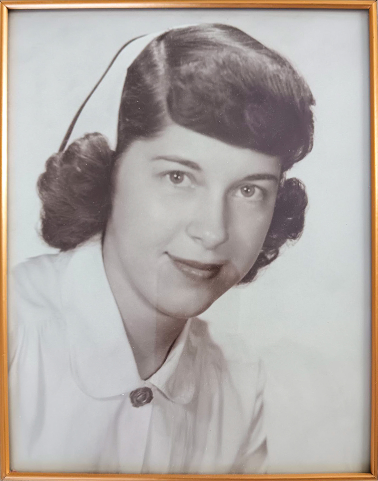 A young May in a white collar shirt, looking confident and stylish.