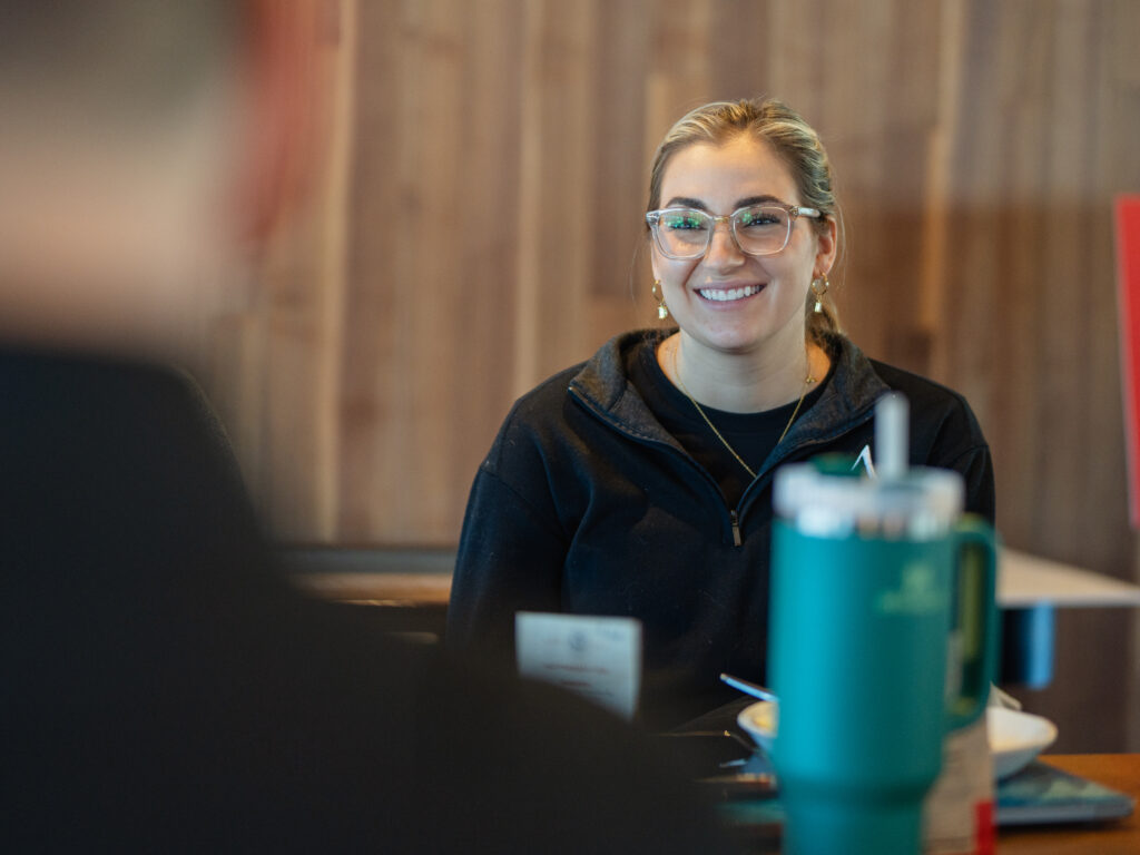 A member of Arrow Senior Living's marketing team smiles at the 2025 sales retreat.