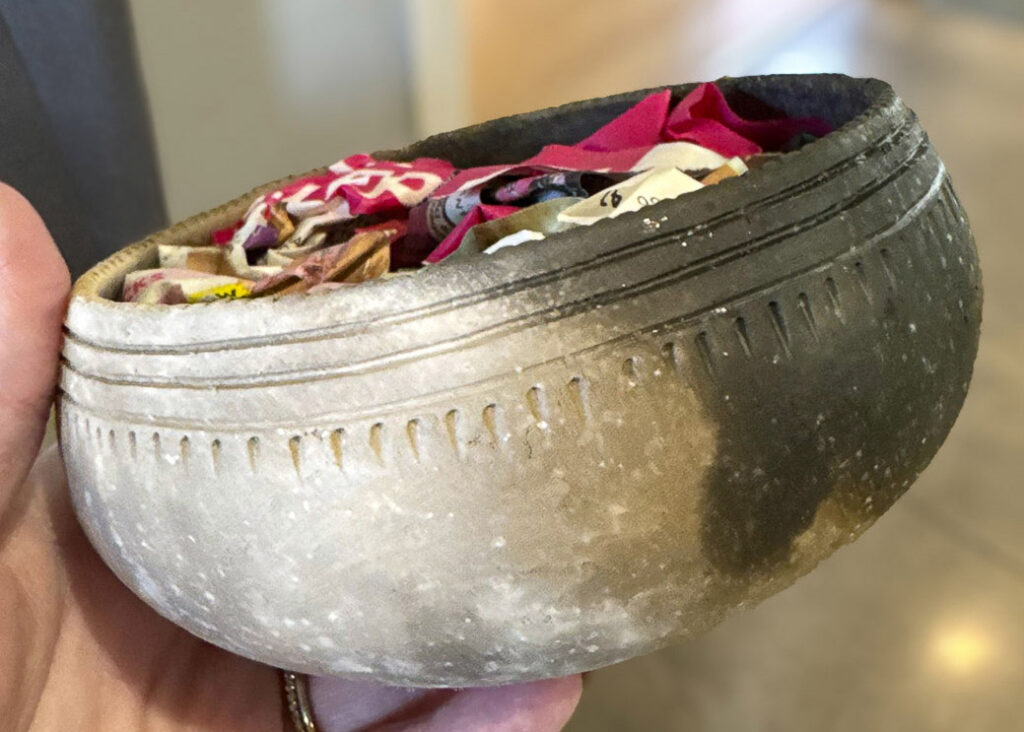 Handcrafted clay bowl by artist Reuben IronHorse-Kent, featuring textured markings and natural pit-fired coloring.