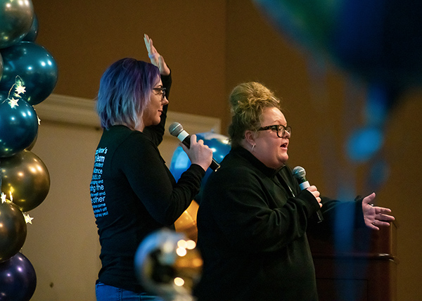 Arrow's COO and a Senior member of leadership give a lively, excited presentation at a retreat.