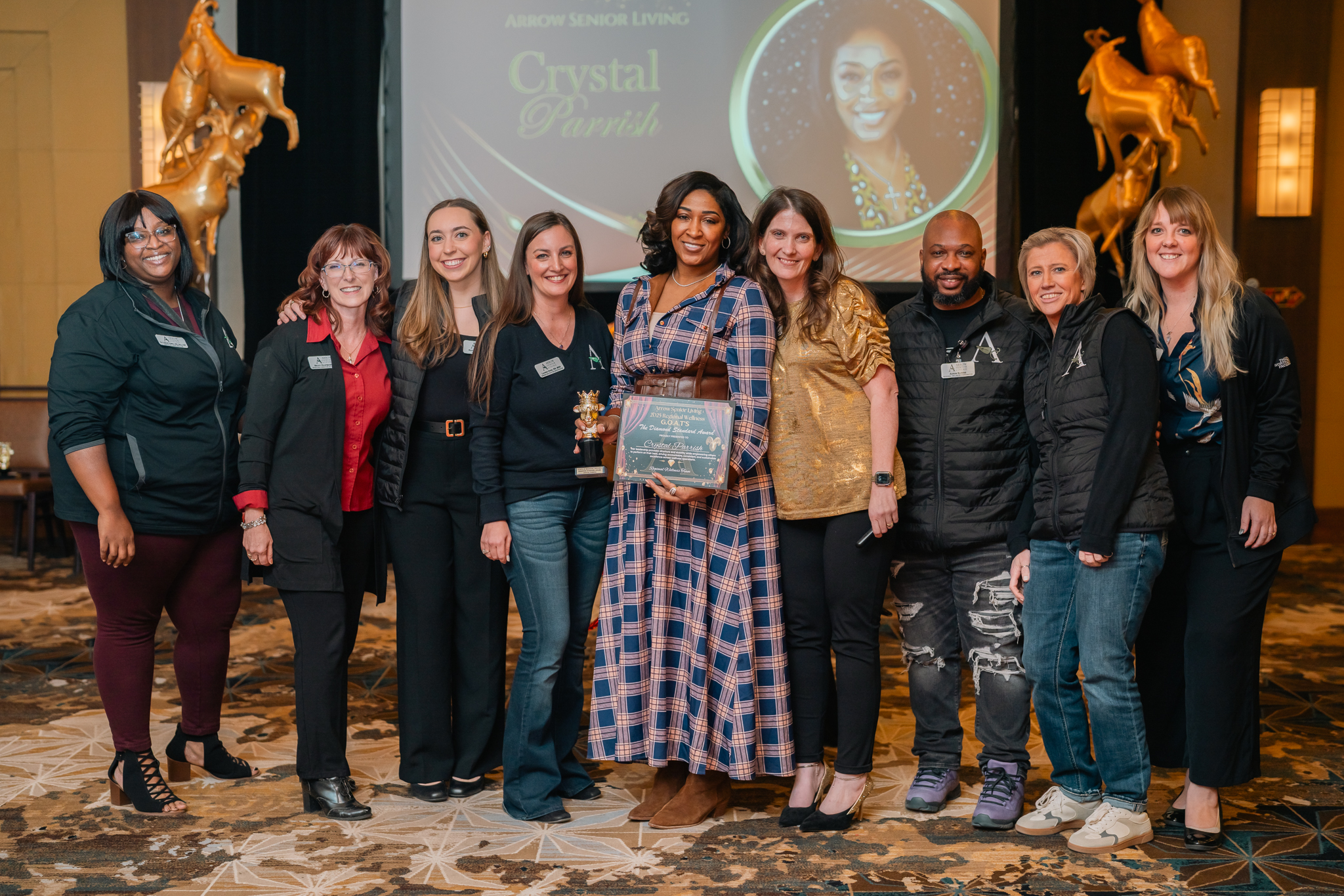 Arrow Senior Living team members pose with an award during the Wellness Growth Summit.