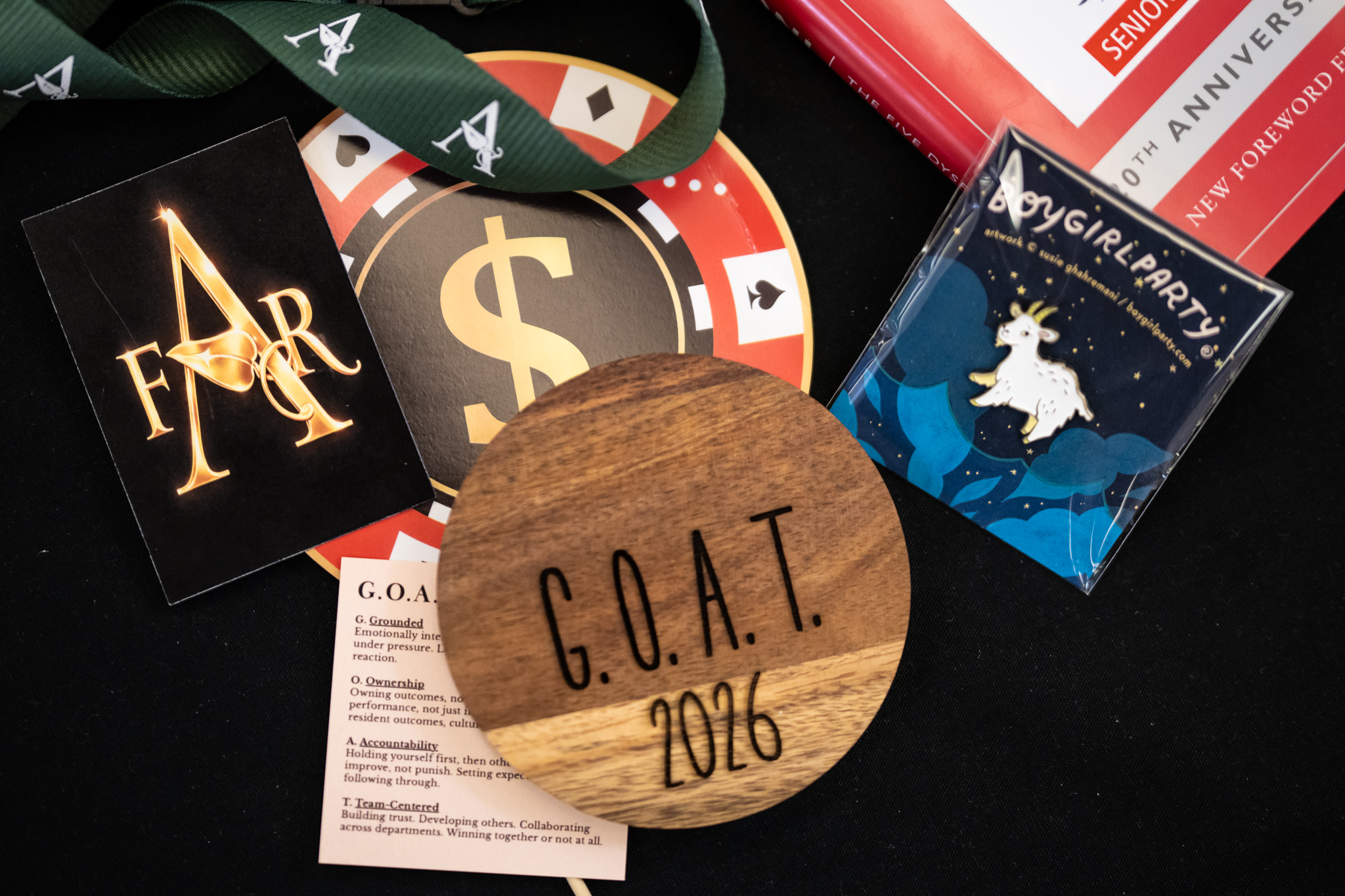 Wellness Growth Summit materials displayed with Arrow Senior Living branding, G.O.A.T. 2026 décor, and event giveaways.